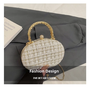 Detailed macro view of white tweed evening clutch with gold mesh handle and rhinestone clasp