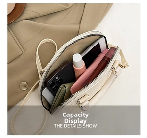 Detail view of cream white croc-embossed shell bag showing large interior storage capacity