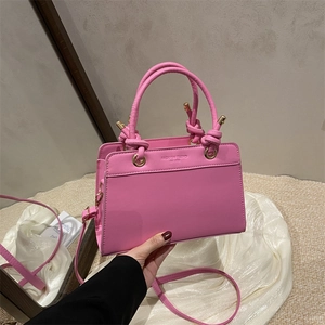Pink trendy large capacity tote bag with knotted handles and gold metal details