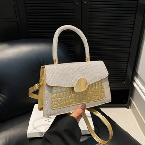 Chic gold crocodile pattern crossbody bag with silver glitter handle and teardrop lock
