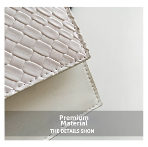 Macro shot of white woven vegan leather texture with precise stitching on small shoulder bag