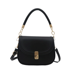 Minimalist black matte leather saddle bag with gold metal hardware and top handle