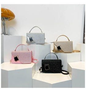 Detailed shot of four sequined square handbags in silver, gold, pink, and black with straps
