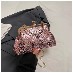 Detailed close-up of pink sequined clutch bag with retro gold handle and chain strap