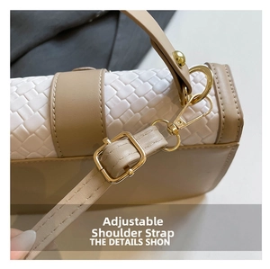 Detail of woven white leather handbag with adjustable shoulder strap and gold hardware
