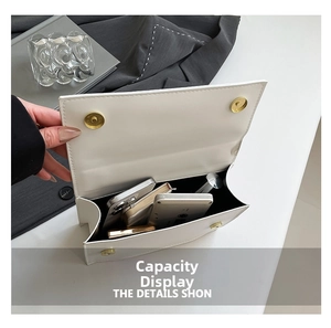 Interior view showing capacity for phone and cosmetics in white leather flap bag