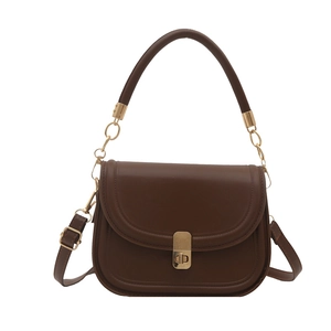 Deep brown leather saddle handbag with gold metal hardware on a white background