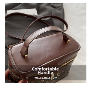 Detailed macro view of retro brown bucket bag with leopard print stitching and gold hardware