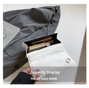 Detail view of the spacious white leather crossbody bag interior with daily essentials