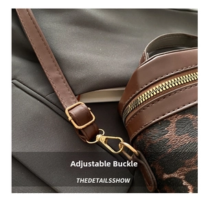 Macro shot of adjustable buckle and metal zipper on leopard print shoulder bag