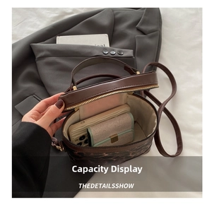 Detailed view of leopard print bucket bag interior showing capacity for phone and wallet