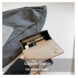 Top-down view of a beige leather crossbody bag showing internal storage for phone and makeup