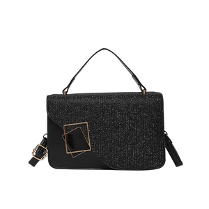 Classic black handbag with glitter flap and golden metal clasp on white background