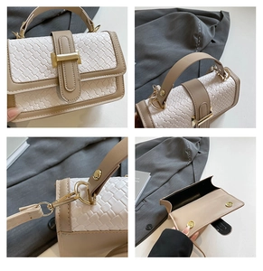Detail view of woven textured handbag showing magnetic clasp and detachable strap