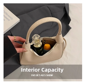 Internal capacity of large beige chain handbag showing phone and cosmetic storage