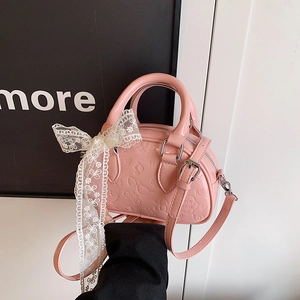 Pink embossed handbag with lace bow and adjustable strap in sweet vintage fashion style