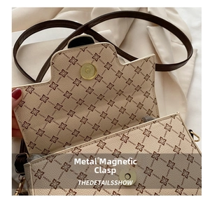 Detailed close-up of the vintage geometric floral print and gold metal magnetic buckle