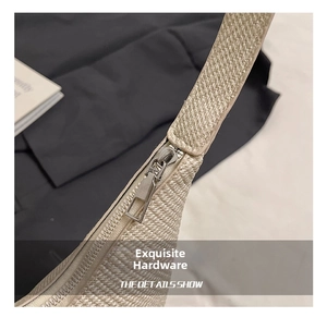 Close-up of premium woven texture and sleek silver geometric zipper on minimalist tote bag