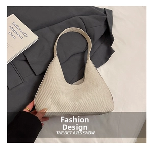 Detailed overhead view of a cream woven hobo bag with textured finish and strap