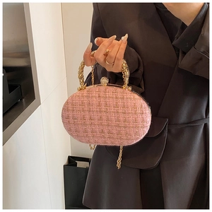 Pink tweed evening clutch with golden snake handle and rhinestone clasp detail