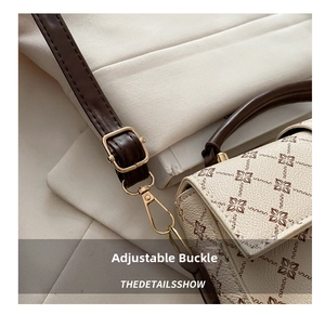Detail of adjustable dark brown strap with gold buckle on vintage crossbody bag
