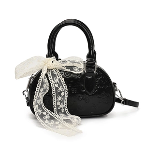 Retro black semi-circle handbag with lace bow and embossed patterns, shown on white background