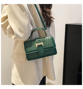 Dark green shoulder bag with crocodile texture and golden metal H-buckle detail