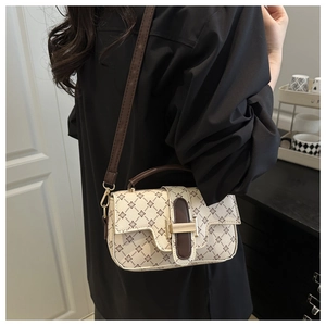 Detailed view of apricot floral crossbody bag worn by model showing size and print