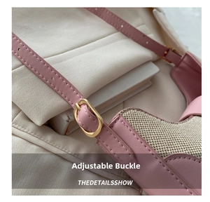 Detail of pink leather saddle bag with woven texture and gold metal adjustment buckle