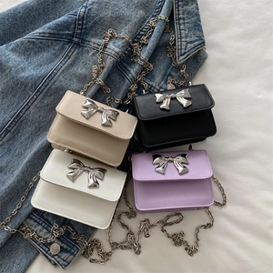 Mini leather crossbody bags with silver metal bow in beige, black, white, and purple colors
