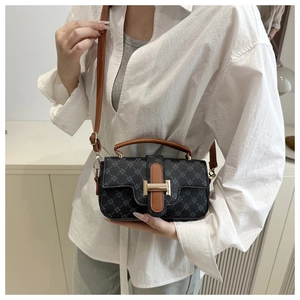 Detail of vintage contrast crossbody bag with gold buckle and classic rhombus pattern