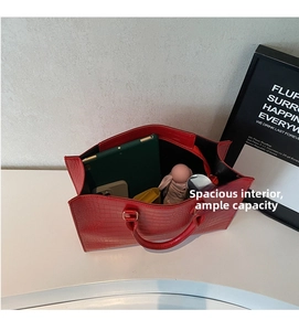 Macro view of red crocodile pattern tote bag interior with large storage capacity