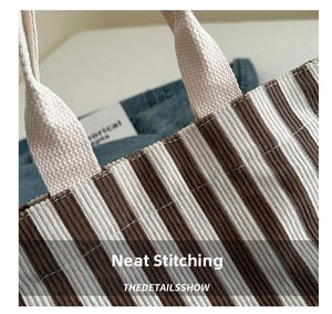 Detailed view of stitching quality on a brown and white striped tote bag