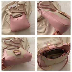 Detail of pink leather and tweed shoulder bag featuring a large gold metal buckle