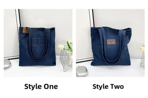 Detail view of deep blue denim tote bags with leather labels and contrast stitching