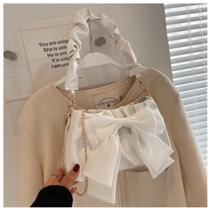 Elegant white shoulder bag with large bow decoration and trendy ruched handle