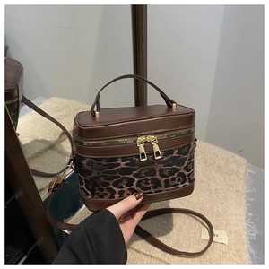 Detail showing high-quality double zippers and leopard print stitching on the box bag