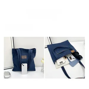 Detail view of the large capacity denim tote bag showing interior storage space and size
