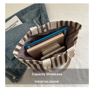 Spacious interior of striped corduroy tote bag showing capacity for books and tablet