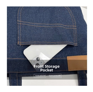 Detail of dark blue denim tote bag with front storage pocket and yellow contrast stitching