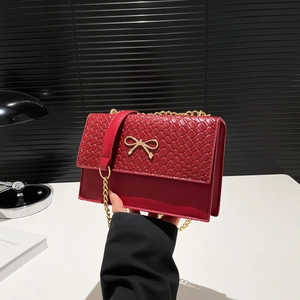 Red quilted leather crossbody bag for women with gold bow buckle and chain strap