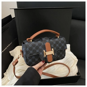 Close-up of vintage floral handbag with premium brown leather handles and golden H-buckle