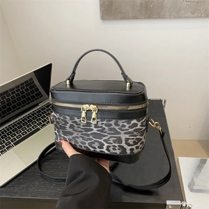 Chic leopard print and black leather vanity bag with gold dual zippers and top handle