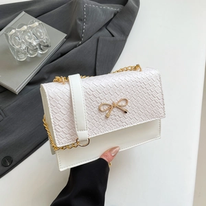 White faux croc leather crossbody bag with golden butterfly clasp and chain strap