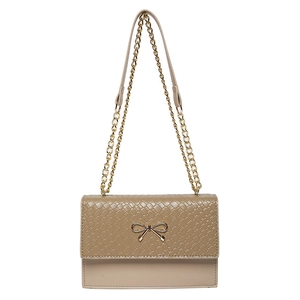 Elegant beige bow lock crossbody bag with woven texture flap and gold chain strap
