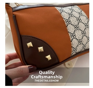 Detail of color-block shoulder bag with clover print and gold stud embellishments