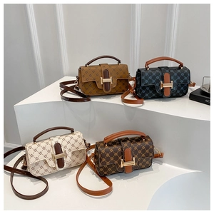 Detail view of the star pattern texture and gold buckle on a stylish mini shoulder bag