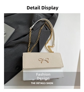 Detail of beige woven flap with gold bow lock and chain strap on small square bag
