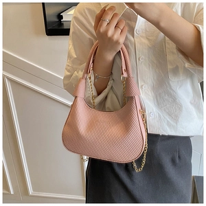 Detail of pink woven leather hobo bag with gold chain and elegant crescent shape