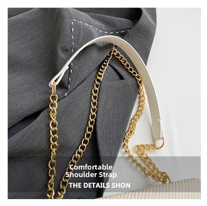 Detail of white faux leather shoulder strap with gold metal chain and D-ring connector